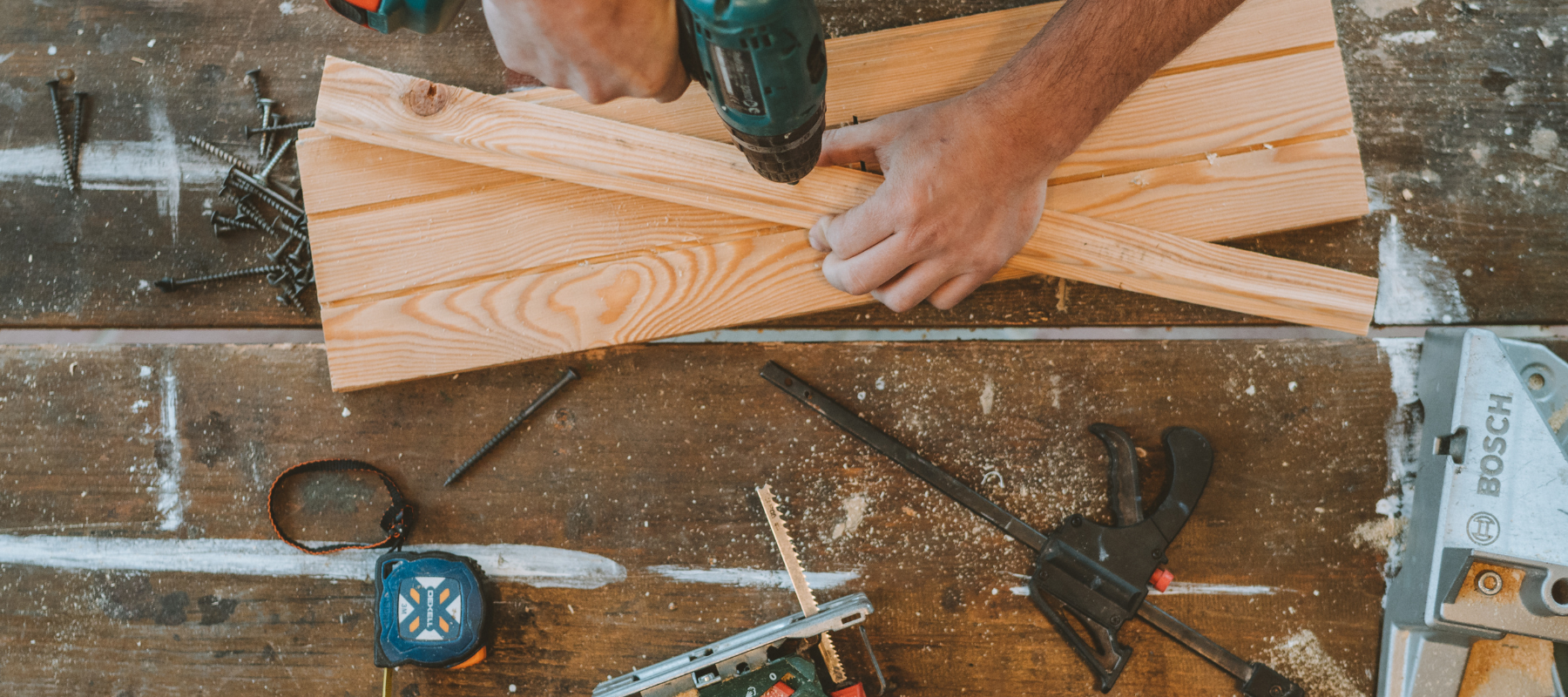 An arial view of a power drill being used on a wood project.
